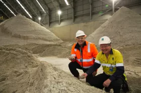 Southern Ports’ CEO Keith Wilks and Talison Lithium Production Manager Guy Meade with stockpiles of record-breaking spodumene (lithium) set for export. (Picture: ©Southern Ports Authority)
