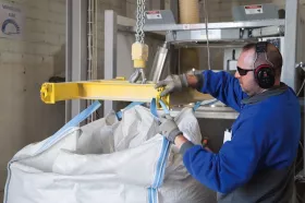 Operator delivers bulk bag, and attaches bag loop straps to the lifting frame. (Pictures: © Flexicon Corporation)
