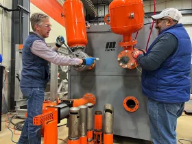 Martin Engineering Business Development Manager Mike Masterson and Product Manager Sid Dev working at the Air Cannon test stand at the company’s industry-leading Center for Innovation. (Copyright © 2024 Martin Engineering)
